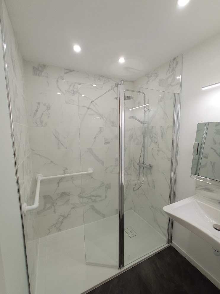 Salle de bains moderne avec douche AKW, finitions élégantes et équipements de qualité.